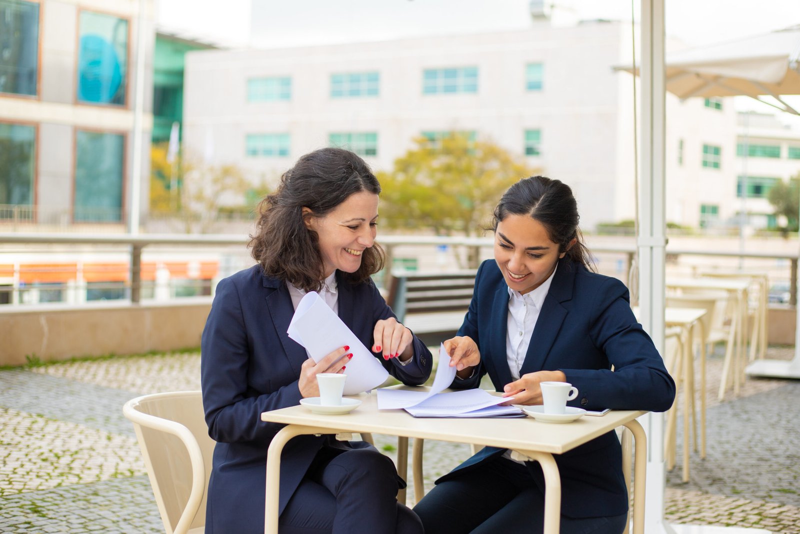 businesswomen drinking coffee and working with papers
