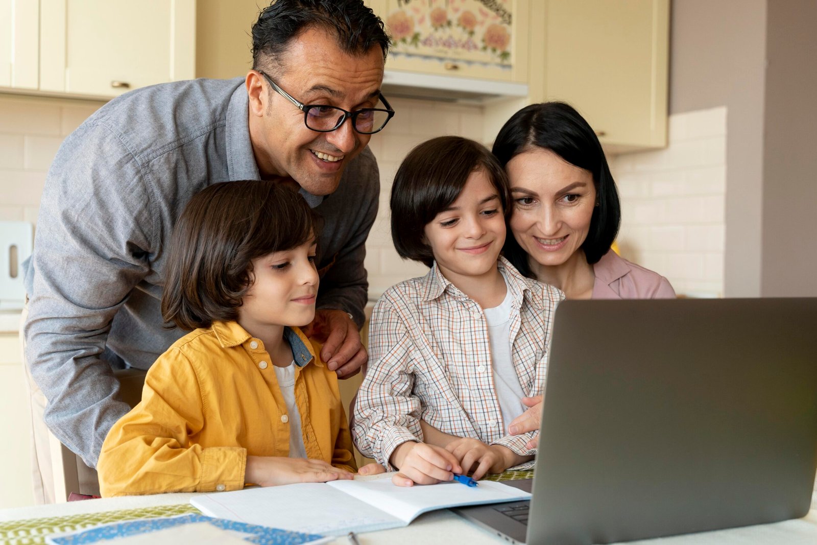 family looking together laptop home