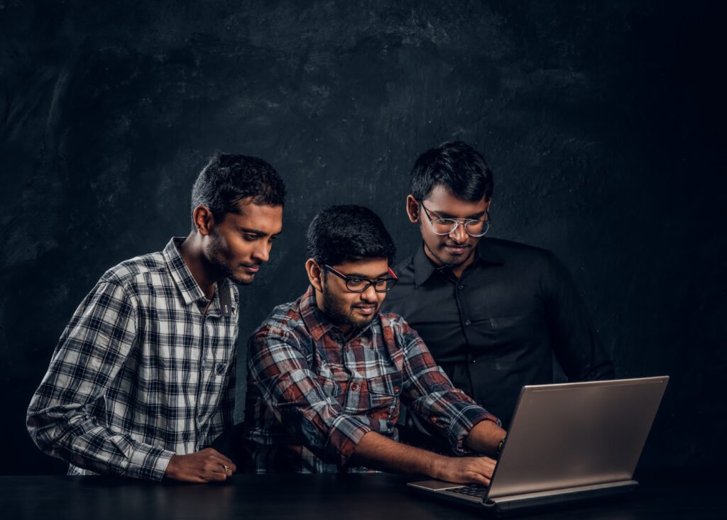 three dark skinned guy chatting in a laptop